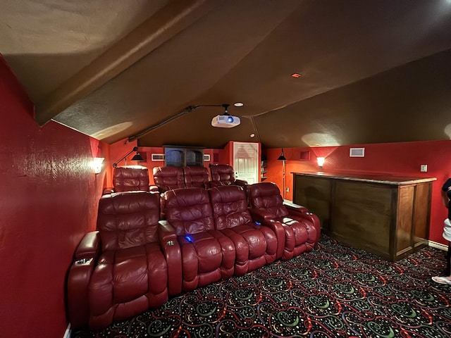 home theater room with vaulted ceiling with beams