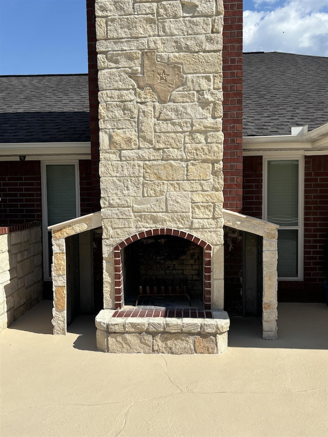 exterior space featuring an outdoor stone fireplace