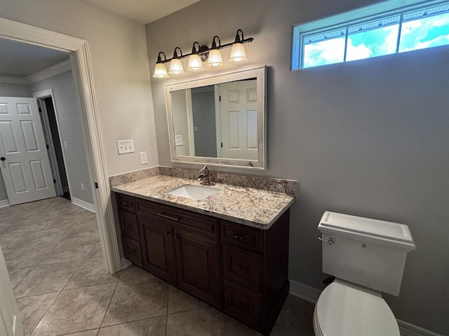 bathroom featuring tile patterned flooring, vanity, toilet, and ornamental molding