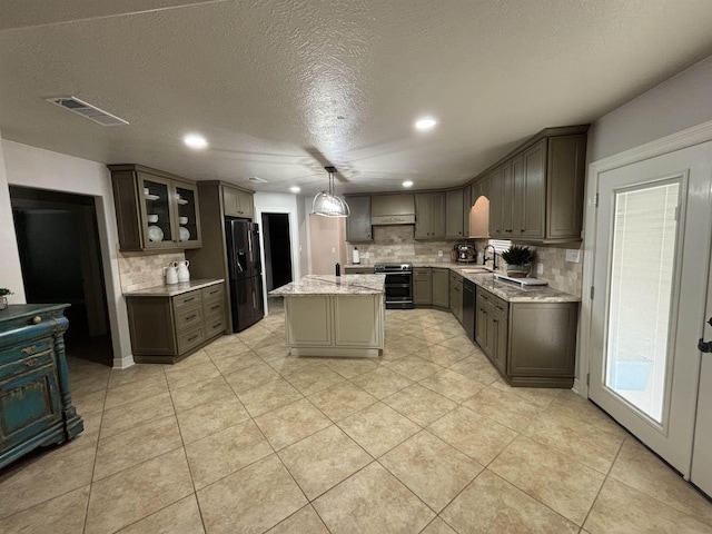 kitchen featuring fridge with ice dispenser, sink, hanging light fixtures, a textured ceiling, and a kitchen island