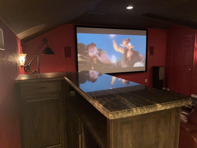 home theater room featuring vaulted ceiling