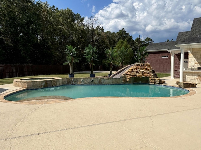 view of pool featuring a patio area, an in ground hot tub, and a water slide