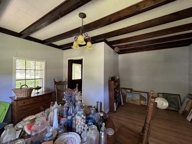 bedroom with beamed ceiling, wood-type flooring, and a chandelier