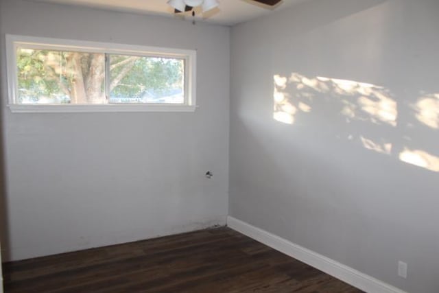 empty room featuring ceiling fan and dark wood-type flooring