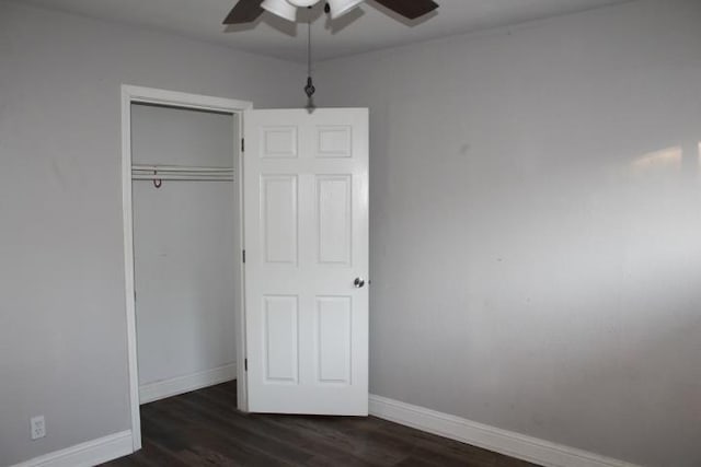 unfurnished bedroom with ceiling fan, a closet, and dark hardwood / wood-style floors