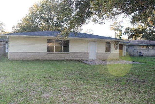 rear view of house with a yard