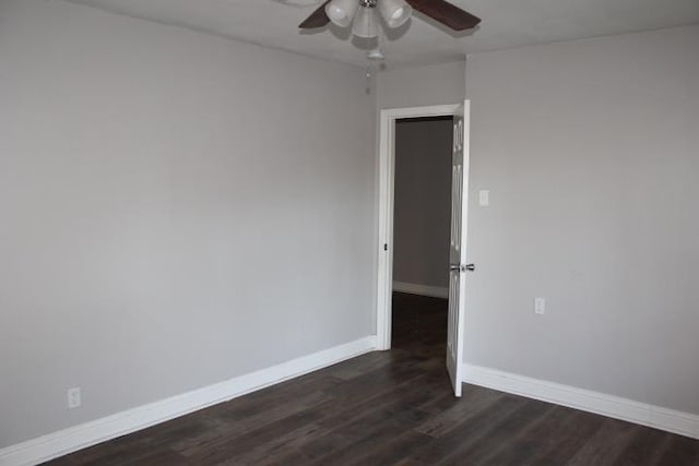 spare room featuring dark hardwood / wood-style floors and ceiling fan