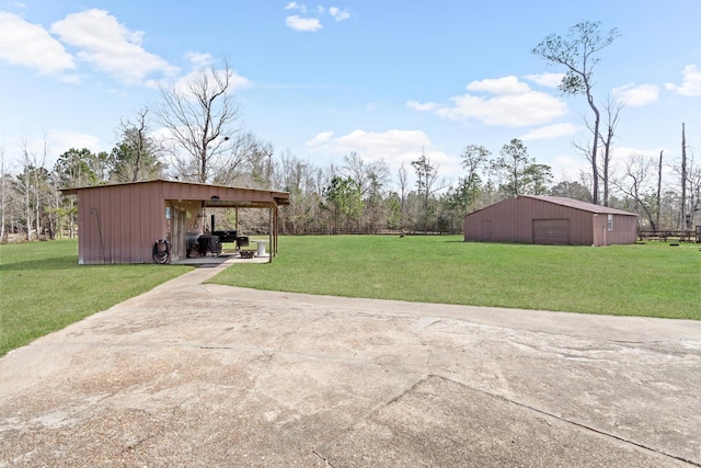 view of yard with a garage and an outdoor structure