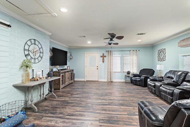 living room with dark wood-type flooring, ceiling fan, and crown molding