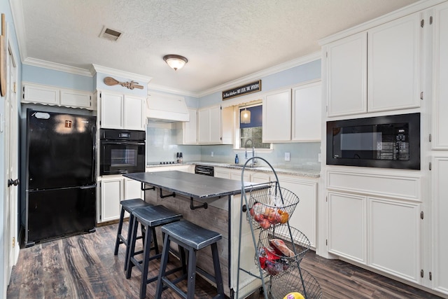 kitchen with white cabinetry, sink, dark hardwood / wood-style flooring, black appliances, and crown molding