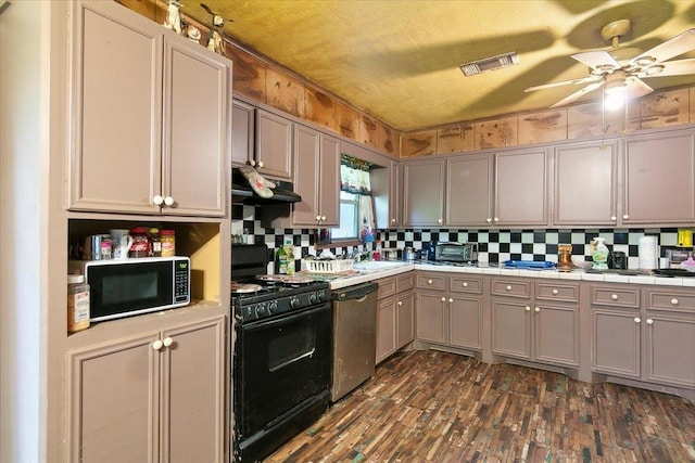 kitchen with sink, stainless steel dishwasher, decorative backsplash, gray cabinets, and gas stove