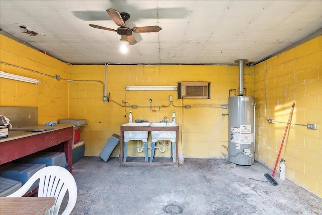 basement with a workshop area, ceiling fan, and water heater