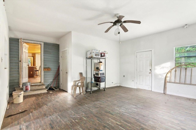 interior space featuring ceiling fan and dark wood-type flooring