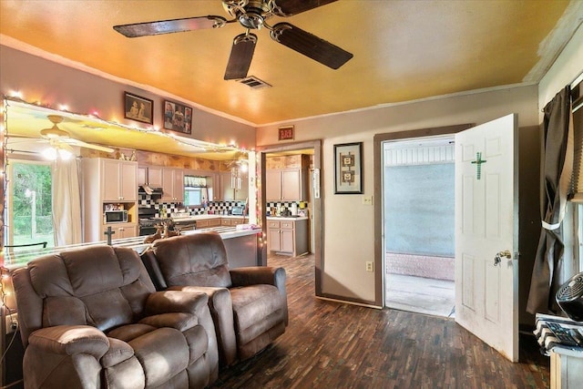 living room with crown molding, dark hardwood / wood-style flooring, and plenty of natural light