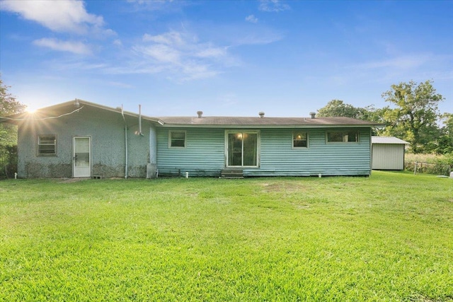 rear view of house featuring a yard