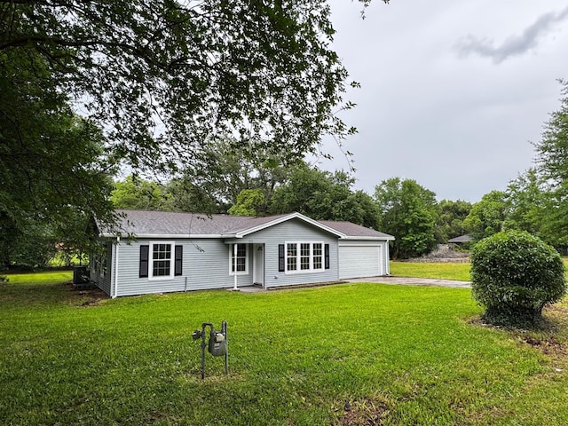 512 N Inwood Dr, Bridge City, TX 77611 - rear view of house featuring concrete driveway, a yard, and a garage