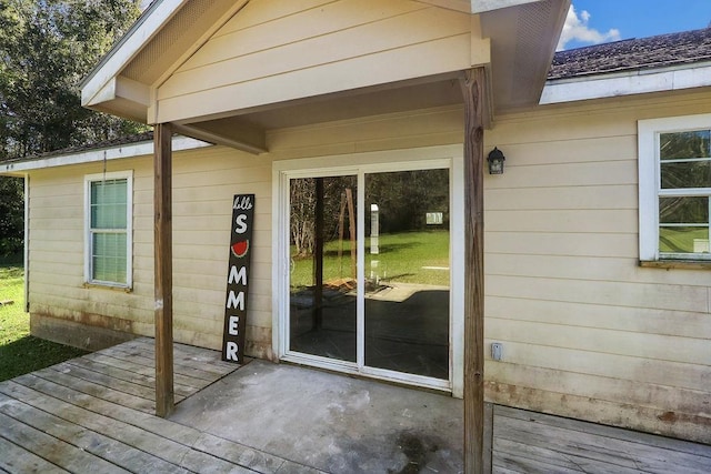 view of exterior entry with a deck