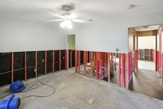 interior space with ceiling fan