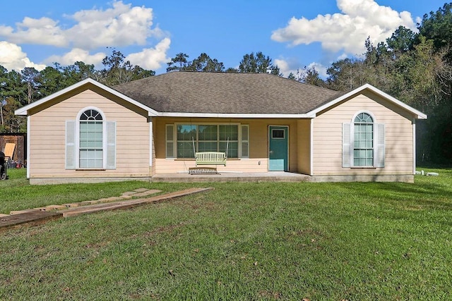 single story home featuring covered porch and a front yard