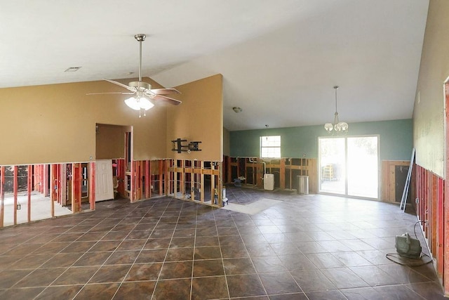 tiled empty room featuring ceiling fan with notable chandelier and high vaulted ceiling