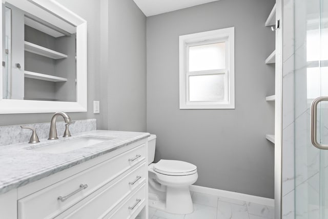 bathroom featuring vanity, toilet, and a shower with door