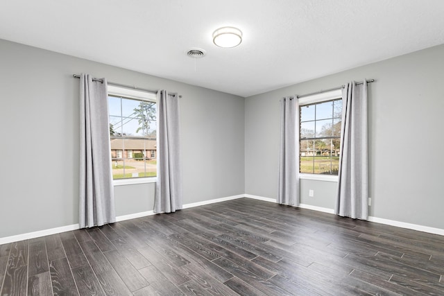 spare room featuring dark hardwood / wood-style floors