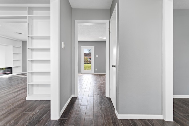 hall featuring dark hardwood / wood-style floors and a textured ceiling