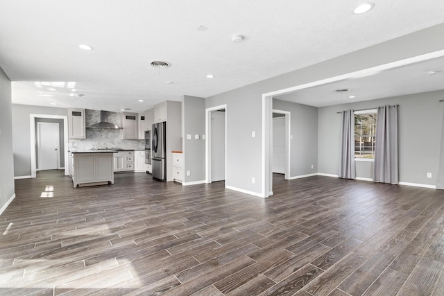 unfurnished living room with dark wood-type flooring