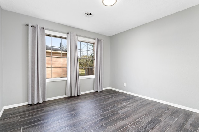 empty room with dark hardwood / wood-style floors