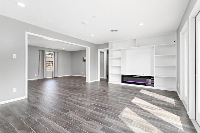 unfurnished living room featuring dark hardwood / wood-style flooring