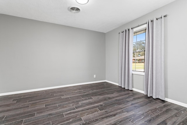 unfurnished room with dark hardwood / wood-style floors