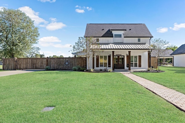 view of front of home featuring covered porch and a front yard