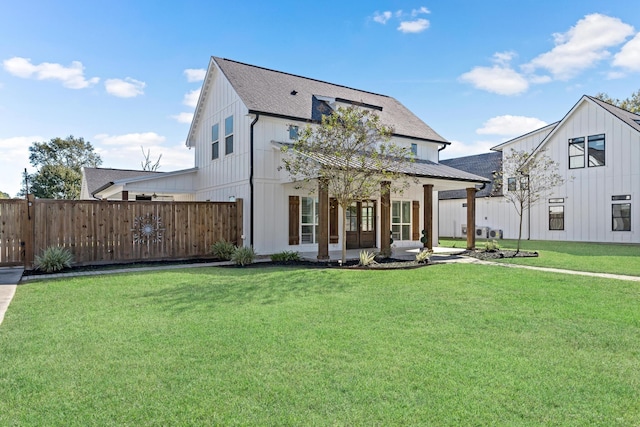 back of house with a lawn and a patio