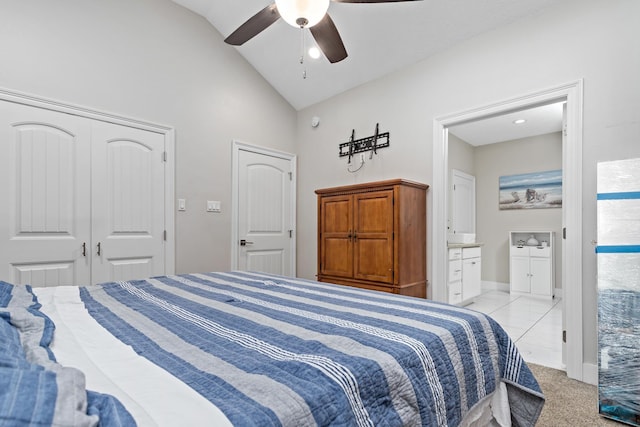 bedroom with a closet, ensuite bathroom, ceiling fan, and lofted ceiling