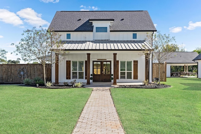 view of front of house featuring french doors and a front yard