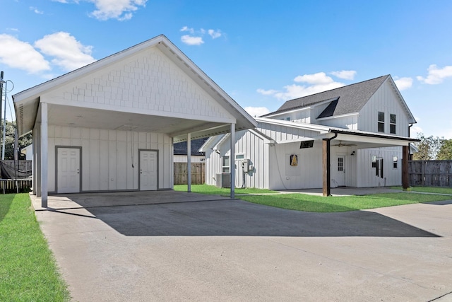 view of front of property with a front yard and cooling unit