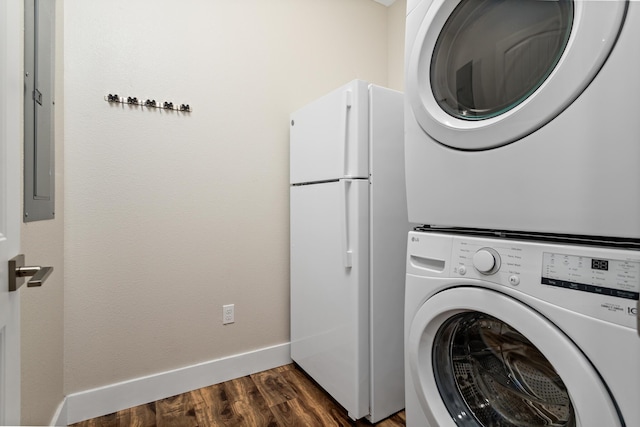 clothes washing area with electric panel, stacked washer and dryer, and dark wood-type flooring