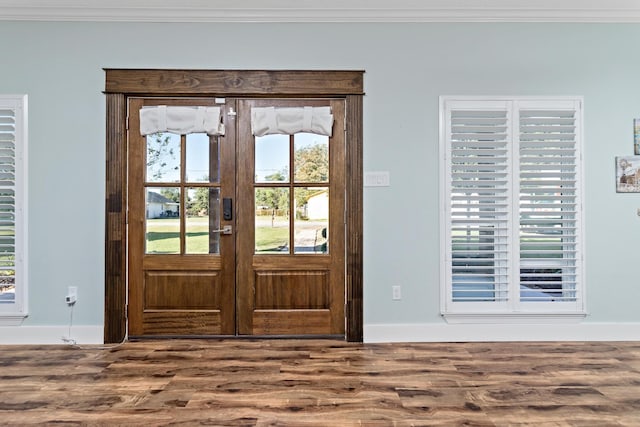 doorway featuring french doors, hardwood / wood-style flooring, a wealth of natural light, and ornamental molding