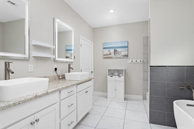 bathroom with vanity and a bath