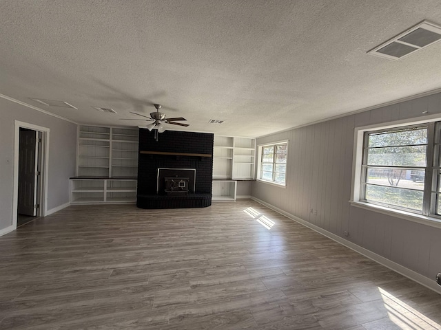 unfurnished living room featuring a ceiling fan, dark wood-style flooring, visible vents, and a textured ceiling
