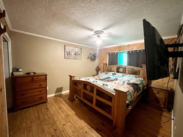 7521 Puntes Ln, Silsbee, TX 77659 - bedroom featuring a textured ceiling, hardwood / wood-style flooring, baseboards, ornamental molding, and a ceiling fan