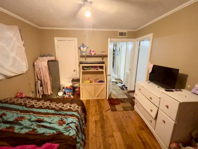7521 Puntes Ln, Silsbee, TX 77659 - bedroom featuring ornamental molding, visible vents, and wood finished floors
