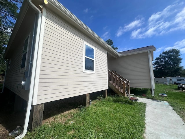 view of property exterior with a lawn