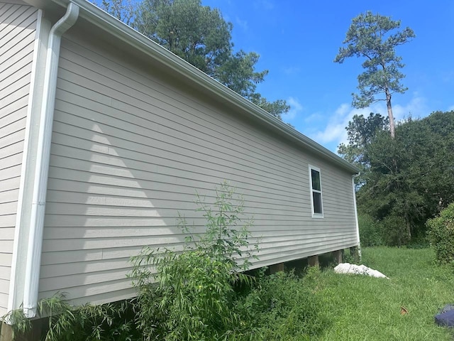 view of property exterior with a lawn