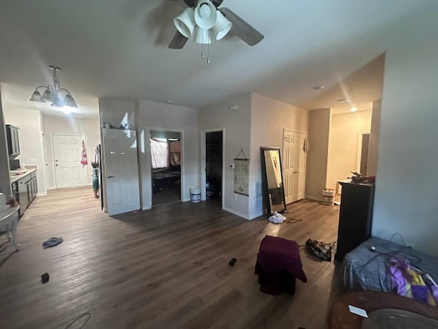 living room featuring wood-type flooring and ceiling fan with notable chandelier