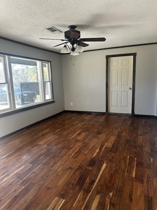 unfurnished room with dark wood-type flooring, ceiling fan, and a textured ceiling