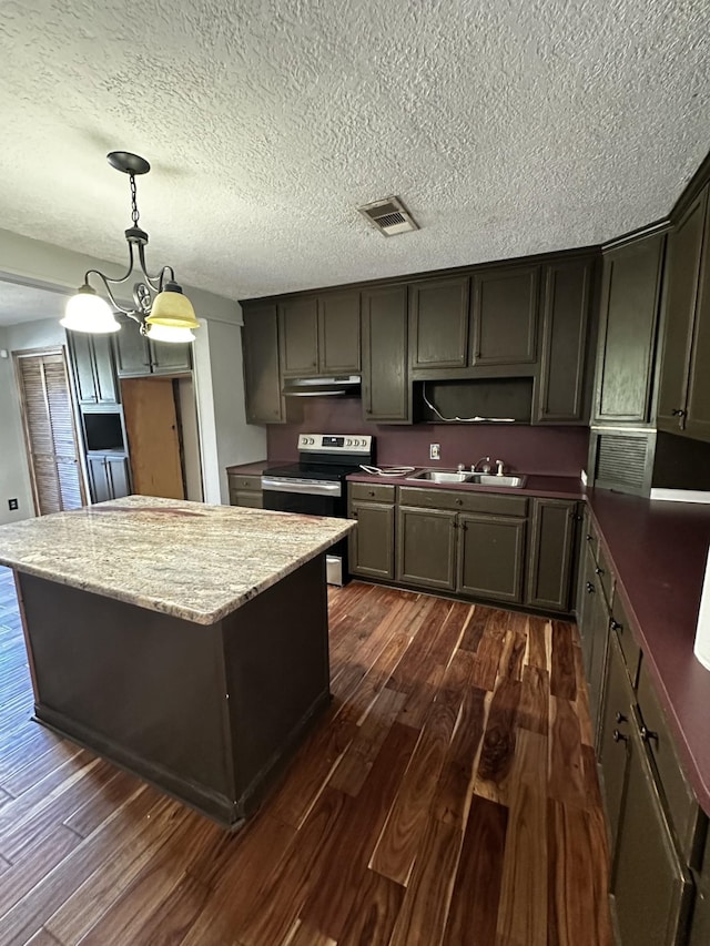 kitchen featuring pendant lighting, sink, stainless steel range with electric stovetop, dark hardwood / wood-style floors, and light stone countertops