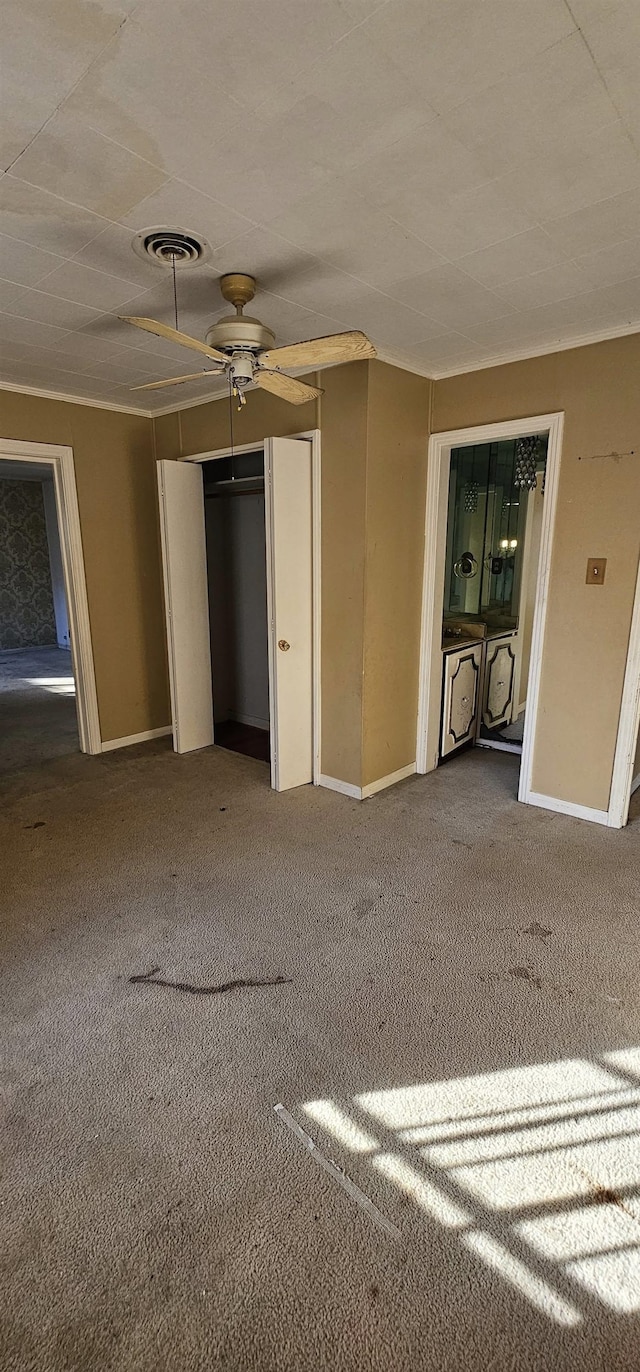 interior space featuring ceiling fan and carpet flooring