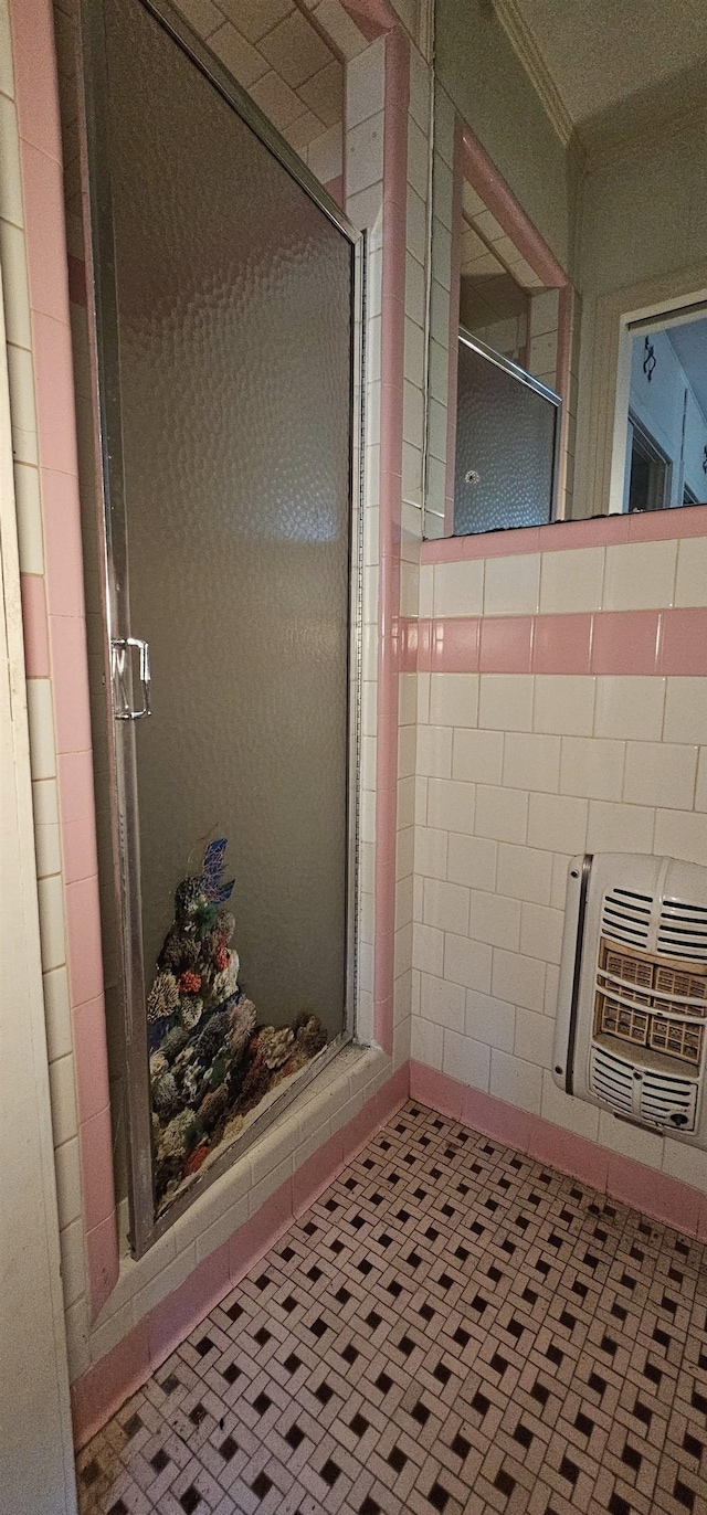 bathroom featuring crown molding, an enclosed shower, and heating unit