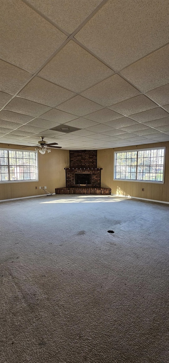 basement featuring a paneled ceiling and carpet flooring